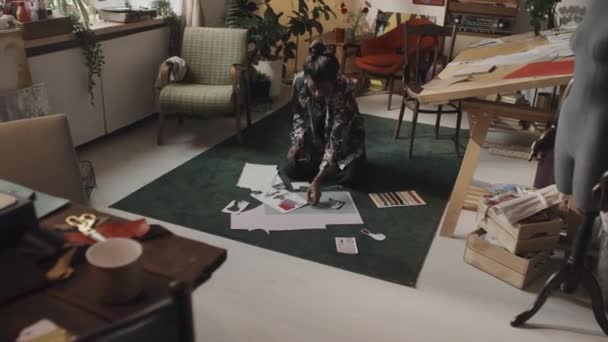 Male Indian Fashion Designer Cutting Out Paper Pattern Sitting Floor — Video Stock