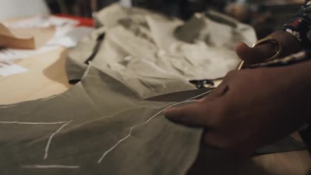Unrecognizable Male Dressmaker Cutting Out Fabric Transferring Paper Pattern Working — 图库视频影像