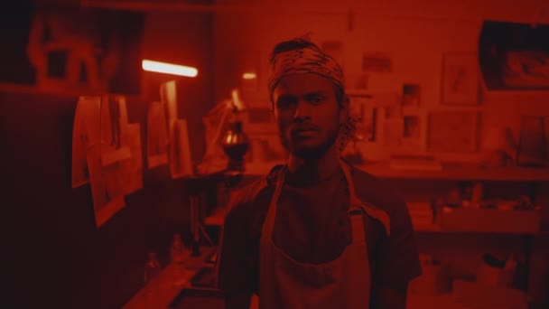 Medium Portrait Young Male Indian Photographer Looking Camera Standing Darkroom — Stockvideo