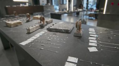 Dükkandaki gri ekranda değerli gümüş mücevherlerin izini sürüyorum.