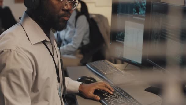 Inclinación Joven Afroamericano Usando Computadora Buscando Base Datos Criminal Del — Vídeo de stock