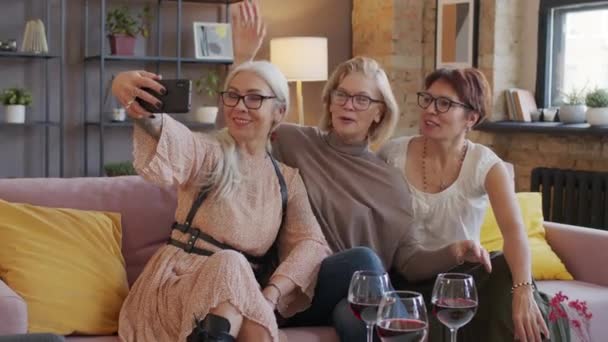 3人の美しい熟女の中出しは 現代のロフトスタイルのアパートで一緒に集まりながら スマートフォンで面白い自撮りの肖像画を取ります ワインを飲みながらチャット — ストック動画