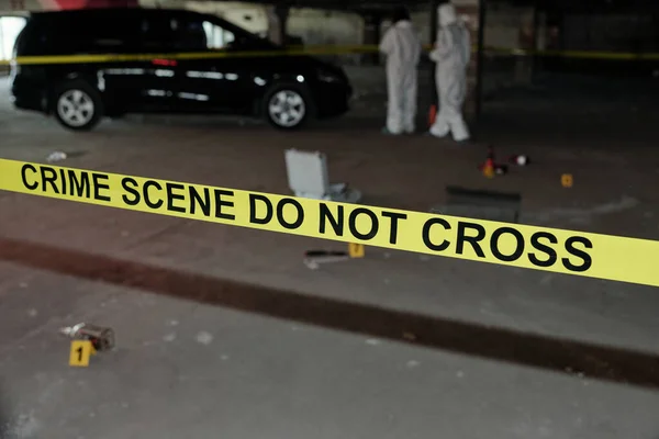 Yellow Tape Surrounding Crime Scene Parking Area Two Experts Protective — Stock Photo, Image