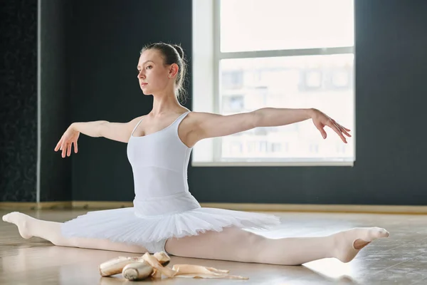 Young Ballerina Outstretched Legs Arms Sitting Twine Floor Spacious Studio — ストック写真