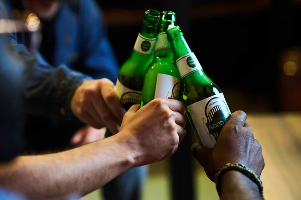 Mãos Três Jovens Interracial Homens Clinking Com Garrafas Cerveja Enquanto — Fotografia de Stock