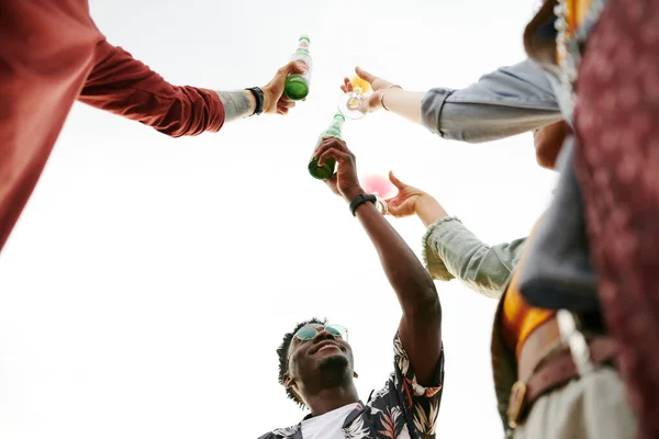 Angle Young Happy Intercultural Friends Cheering Bottles Beer Cocktails While — Stock Photo, Image