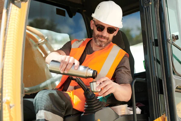 Male Driver Construction Machine Pouring Hot Tea Water Thermos Gearshift — Stock Photo, Image