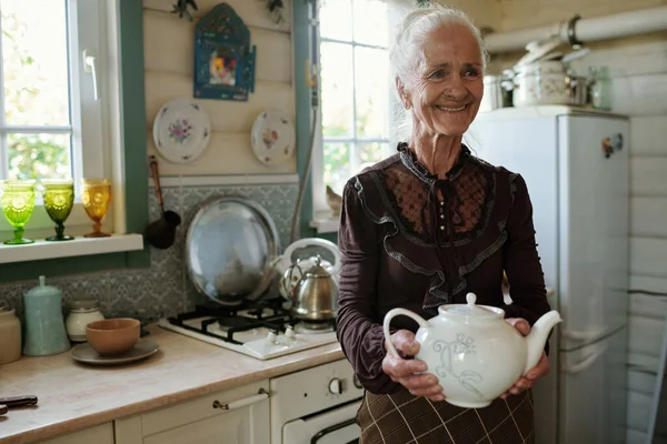 Smiling Grandmother Smart Casualwear Carrying White Porcelain Teapot Tea Living — Stock Photo, Image