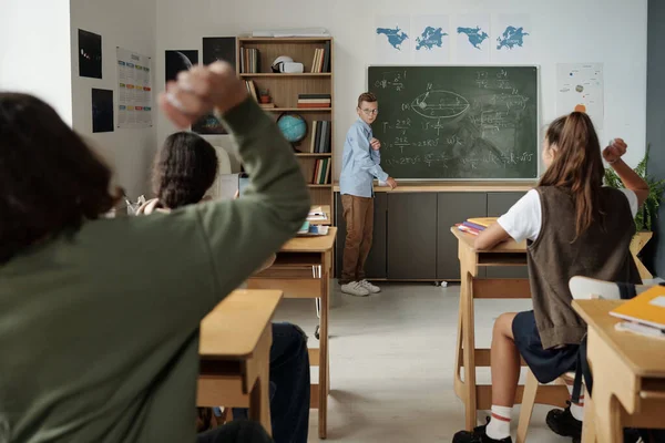 Cute Schoolboy Standing Blackboard Written Formulas While Classmates Throwing Crumpled — Stock Photo, Image