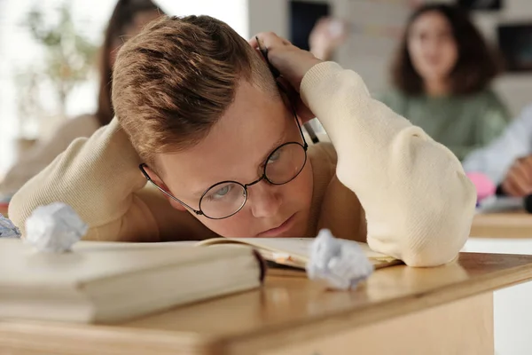 Offended Upset Schoolboy Bending Desk Protect His Head Crumpled Papers — Stock Photo, Image