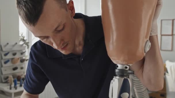 Tilt Shot Modern Professional Craftsman Assembling Fixing Parts Leg Prosthesis — Stock Video
