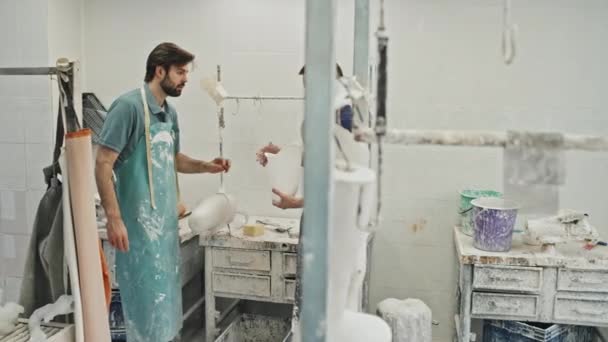 Young Craftsman Holding Prosthetic Leg Socket Standing Front His Colleague — Stock Video