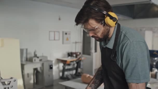 Tilt Young Adult Bearded Caucasian Man Wearing Protective Eyewear Headphones — Stock Video