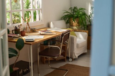 Pencere kenarında duran kağıt, not defteri ve diğer yaratıcı eşyalarla modern sanatçının ev veya oda stüdyosunun bir parçası