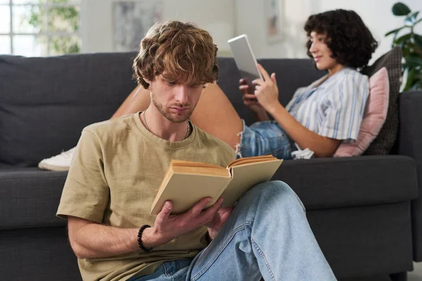 Serious Guy Reading Novel Captivating Plot Young Woman Tablet Sitting — Stock Photo, Image