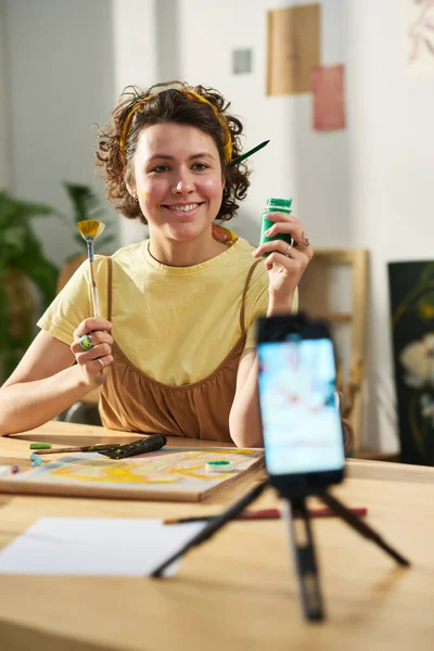 stock image Happy young creative woman looking at smartphone camera during livestream or online masterclass for subscribers of her channel