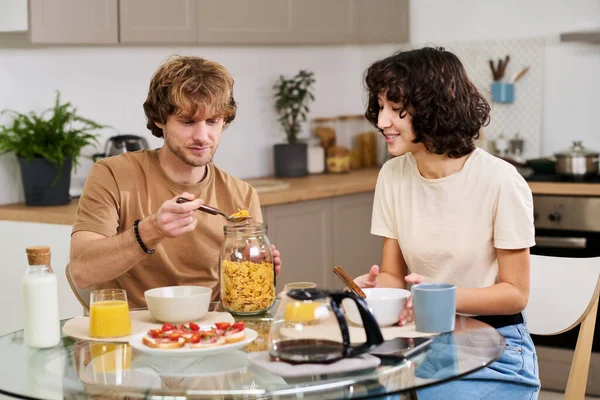 Young Man Taking Some Cornflakes Jar While Preparing Breakfast Kitchen Royalty Free Stock Images