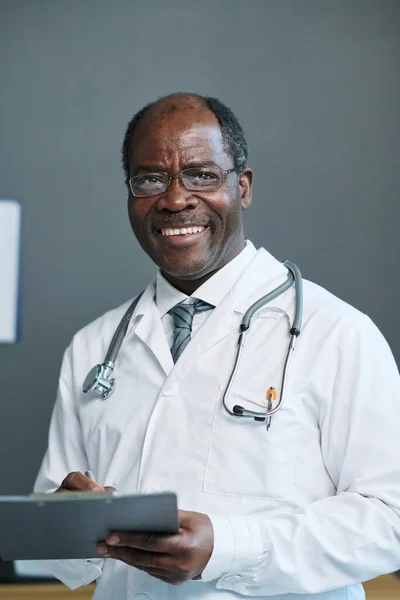 Successful Experienced General Practitioner Medical Document Looking Camera Smile While — Stock Photo, Image