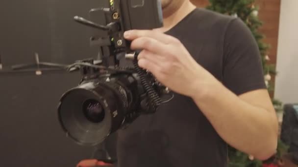Tilting Young Male Caucasian Videographer Holding Professional Video Camera Getting — Stock Video