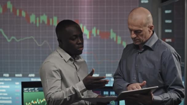 Modern Mature Caucasian African American Trading Analysts Standing Office Watching — Stock Video