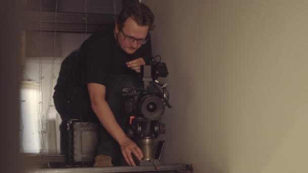 Medium Long Cameraman Eyeglasses Working Set Indoors Evening — Stock Video
