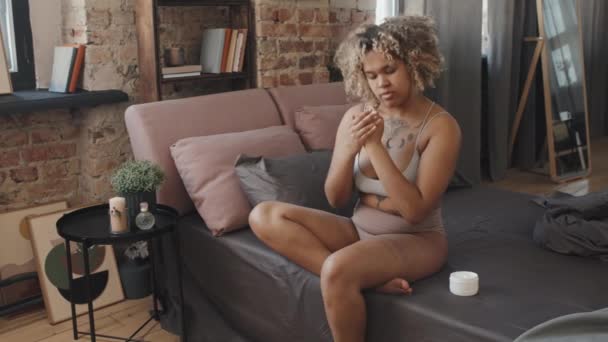 Moderna Jovem Mulher Negra Sentada Cama Quarto Loft Manhã Aplicando — Vídeo de Stock