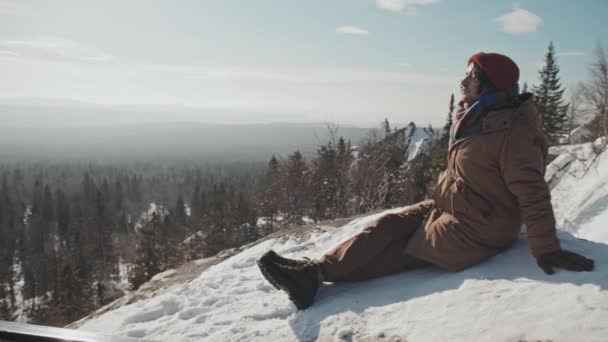 Młody Kaukaski Człowiek Siedzi Szczycie Góry Pokryte Śniegiem Korzystających Słoneczny — Wideo stockowe