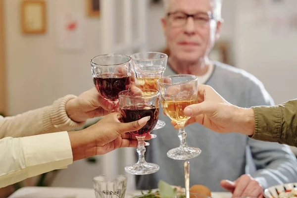 在庆祝生活事件的同时 不同文化间家庭的成员在庆祝节日的桌上 与一杯自制的葡萄酒握手言和 — 图库照片