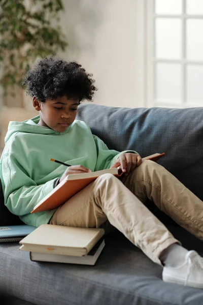 Serious African American Schoolboy Open Encyclopaedia His Knees Reading Article — Stock Photo, Image