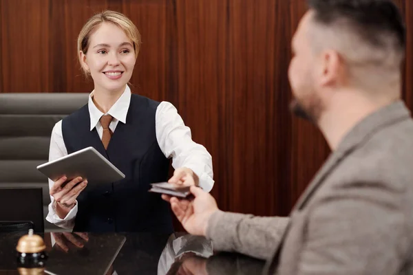 Young Smiling Receptionist Giving Passport Back Male Guest Counter Registration — Stock Photo, Image
