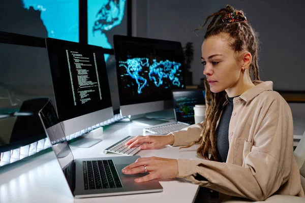 Молода Серйозна Жінка Програмістка Дивиться Дані Екрані Ноутбука Сидячи Робочому — стокове фото