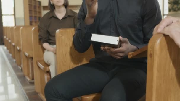 Tilt Shot Modern Young Adult Priest Sitting Bench Catholic Church — Vídeos de Stock