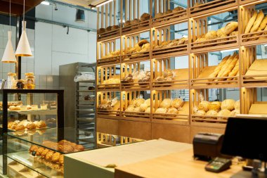Çeşitli hamur işleri ve ekmekler sergilenen fırıncı işyeri ve kafeteryadaki tablet ve ödeme terminalli tezgah masası