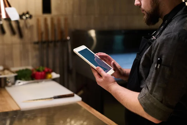 Close Chef Uniform Holding Tablet While Standing Kitchen Table Front — Stock Photo, Image