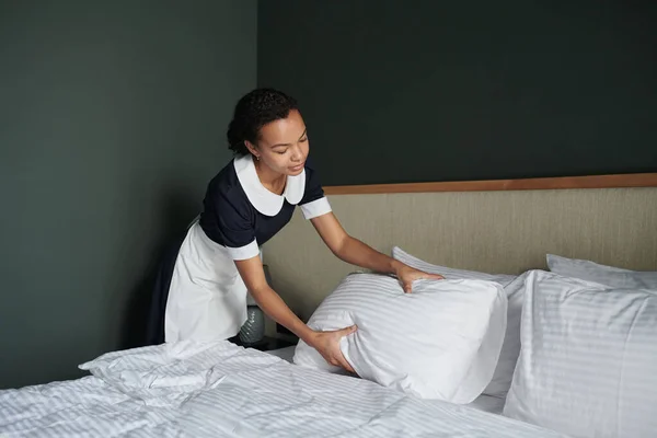 Young Chambermaid Bending Double Bed Clean Bedclothes Straightening Pillows While — Stock Photo, Image
