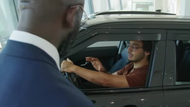 Shoulder Shot Young Middle Eastern Man Sitting Crossover Car Dealership — Vídeo de Stock