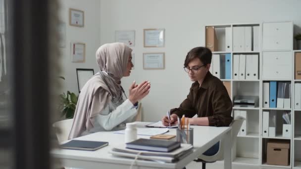 Jonge Vrouwelijke Patiënt Kijkt Naar Moslimarts Hijab Luistert Naar Haar — Stockvideo