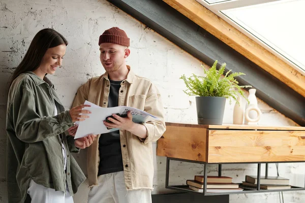 stock image Young confident businessman showing financial document to happy female colleague and explaining its main points at working meeting