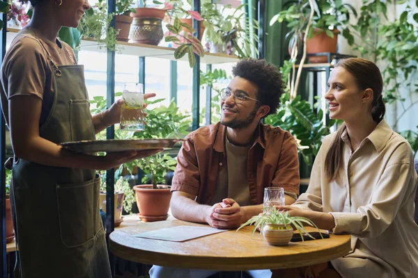 Happy Young Man Woman Sitting Table Green Plants Cafe Looking — Stock Photo, Image