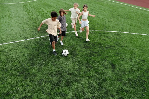 Team Four Intercultural Friends Classmates Activewear Running Soccer Ball Green — Stock Photo, Image