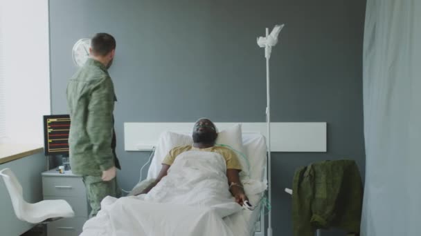 彼の無意識の友人の批判的な状態を目撃した軍人男性は ヒメを救うために医者を呼び出します — ストック動画