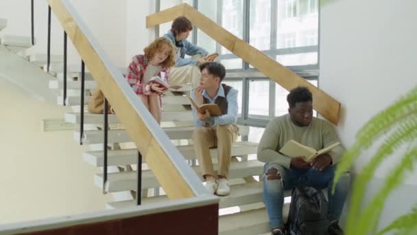 Group Ethnically Diverse College University Students Sitting Stairs Reading Lecture — Stock Video