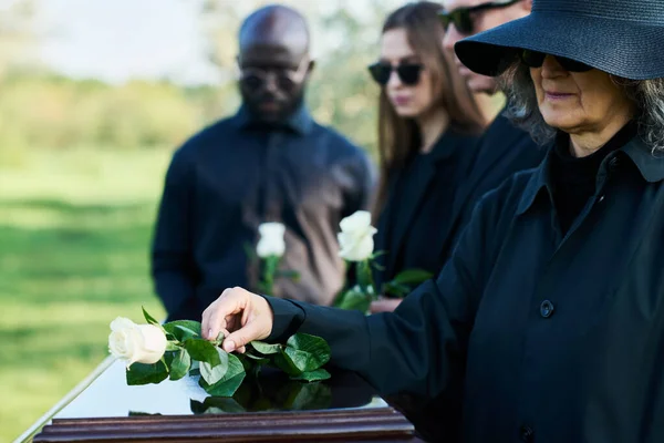 Mature Grieving Woman Mourning Clothes Putting White Rose Coffin Top — Stock Photo, Image