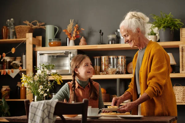 Happy Cute Girl Pigtails Looking Her Grandmother While Having Tea — Stock Photo, Image