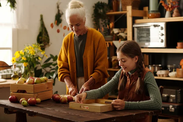 Senior Woman Yellow Cardigan Chopping Fresh Apples Wooden Table While — Stock Photo, Image
