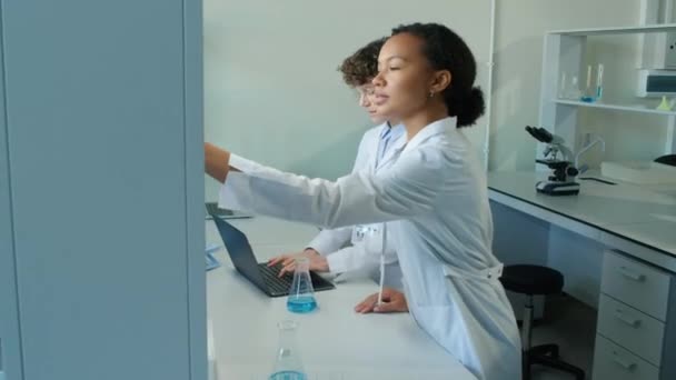 Бічний Знімок Біраової Жінки Лабораторному Пальто Приймає Колбу Фіолетовою Рідиною — стокове відео