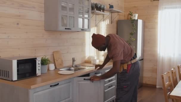 非洲裔美国人专业水管工在厨房修理后打开水龙头检查水压 — 图库视频影像
