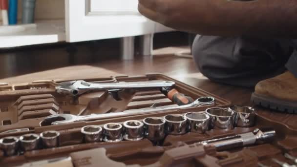 Close Shot Unrecognizable Black Plumber Sitting Floor Choosing Tools Repair — Stock Video