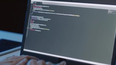 Gece vakti dizüstü bilgisayarın klavyesinde tanımlanamayan kişinin ellerini kapat.