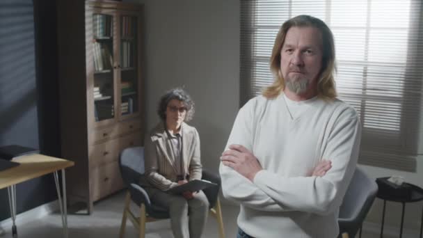 Psikolog Ofisinde Kollarını Kavuşturup Kameraya Bakan Uzun Saçlı Olgun Bir — Stok video